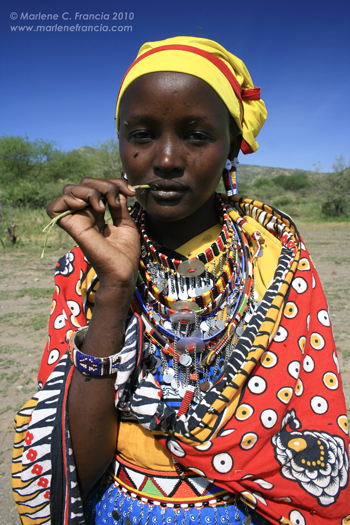 Masai Woman with chewing stick by Marlene C. Francia